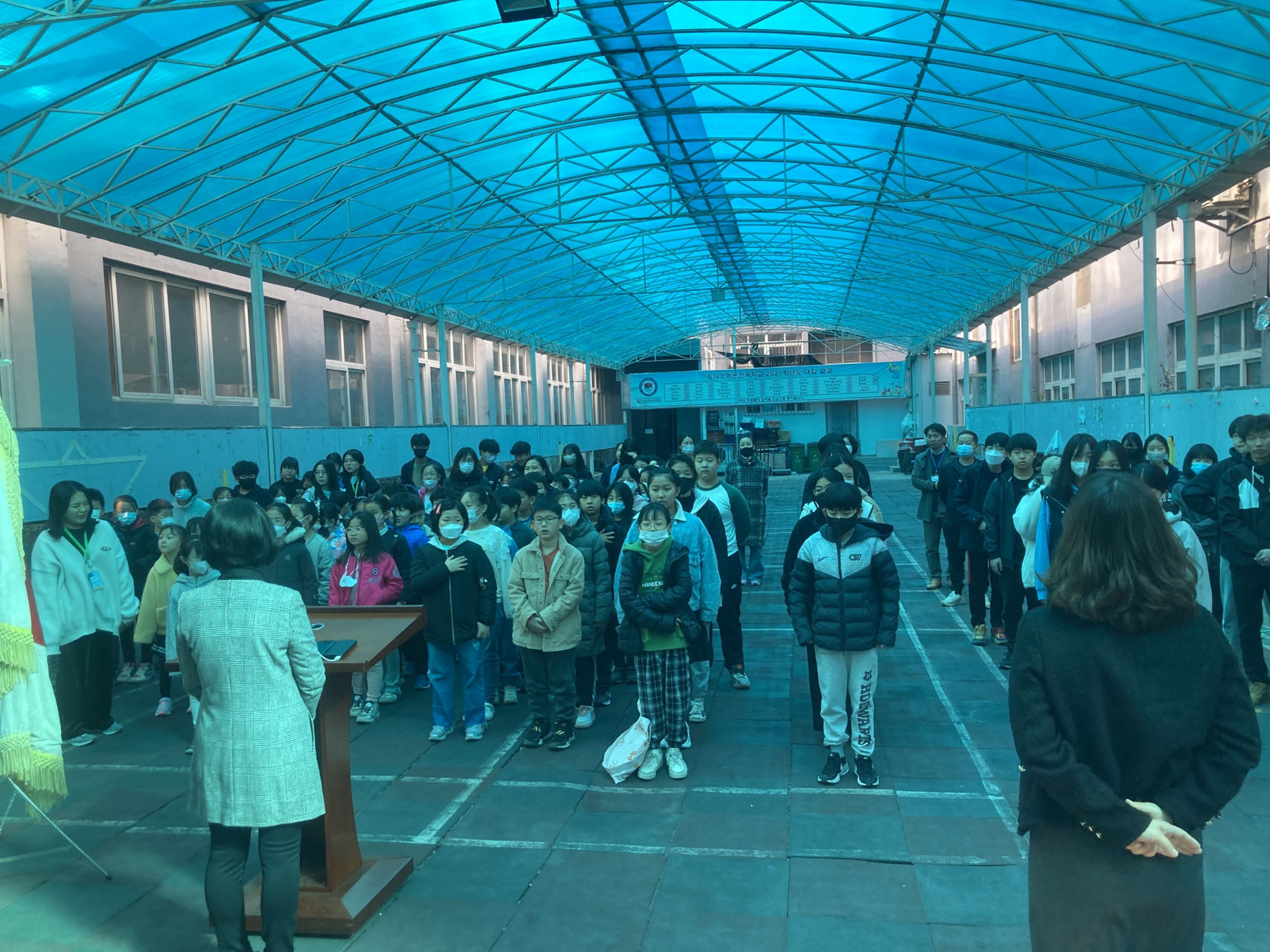 Faculty members and students convene for the first morning assembly of March of the Hangeul School in Qingdao