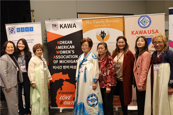 KAWA members taking a picture in front of the banners of the participating organizations