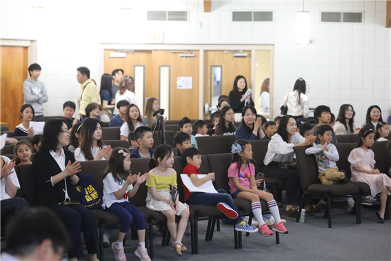 Students and parents focusing on presentations of the participants